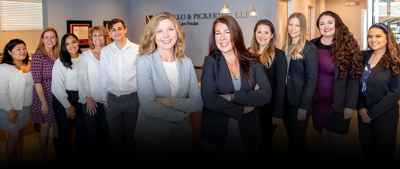 Legal professionals standing in the lobby of Mello & Pickering, LLP.